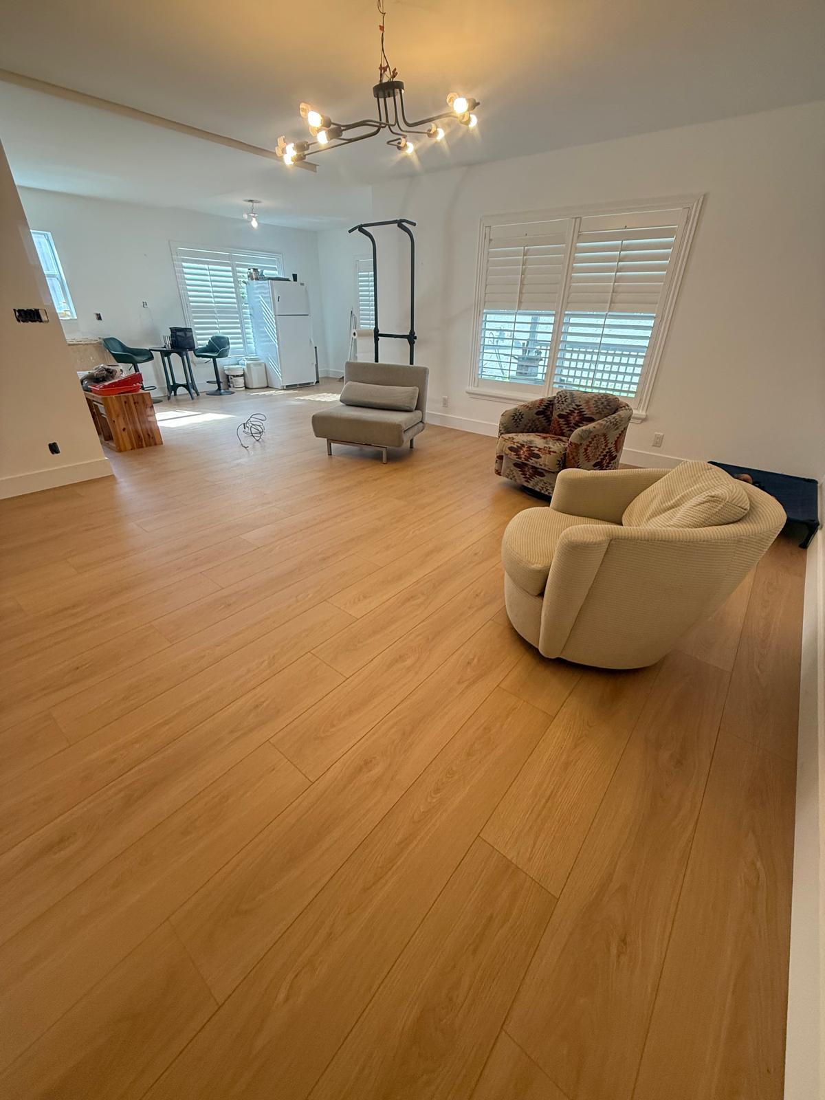 Professional flooring installers working on vinyl and tile floors in a Florida home