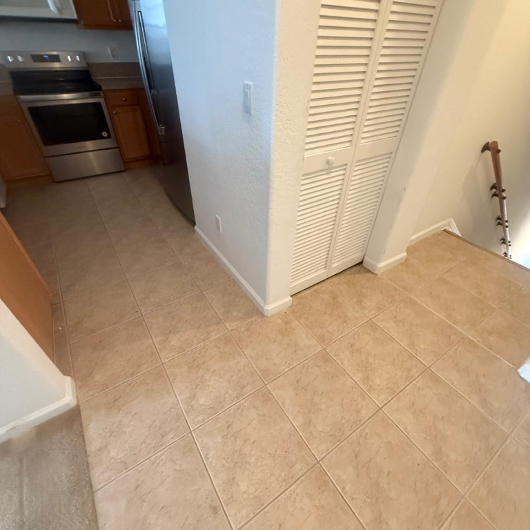 Before: Kitchen Tile Old beige ceramic tile floor in kitchen before renovation.