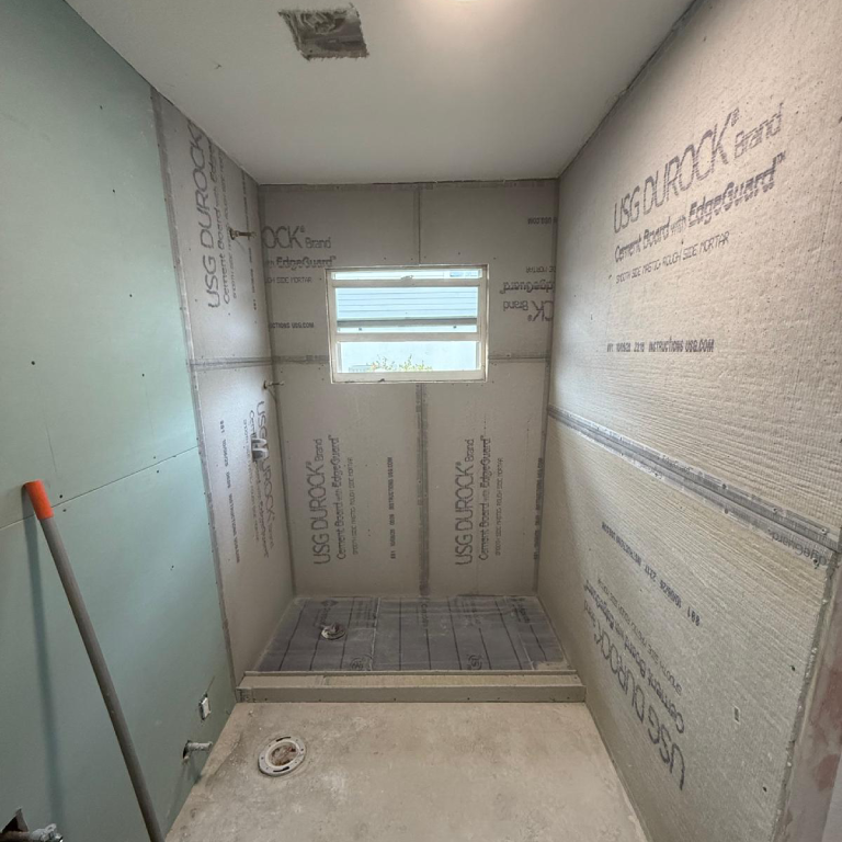 Tile Flooring Installation Process Tile flooring installation in progress with shower base prepared for tile work