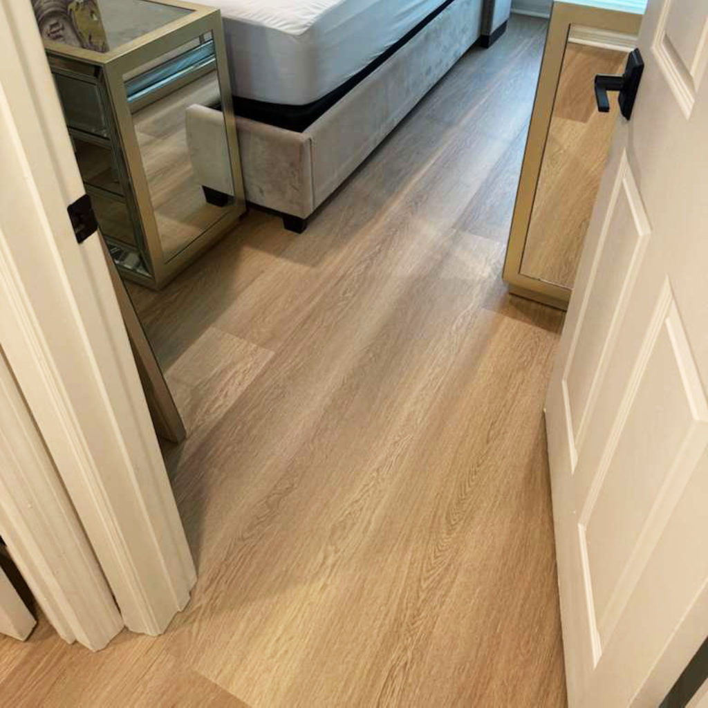 Waterproof Luxury Vinyl 8mm in Creme Brulle installed in a bedroom