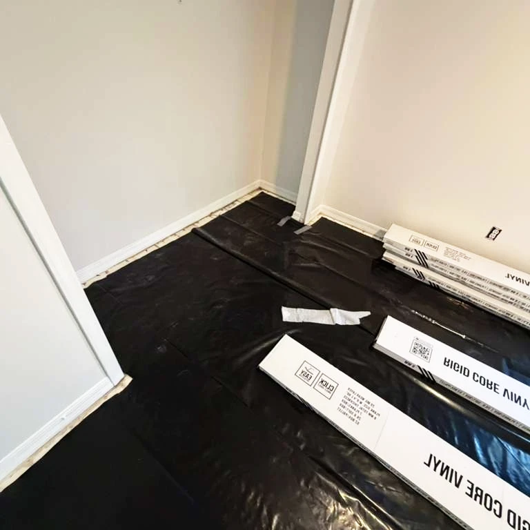 Vinyl Flooring Installation Preparation with Moisture Barrier Room prepared for vinyl flooring installation with moisture barrier and vinyl plank boxes