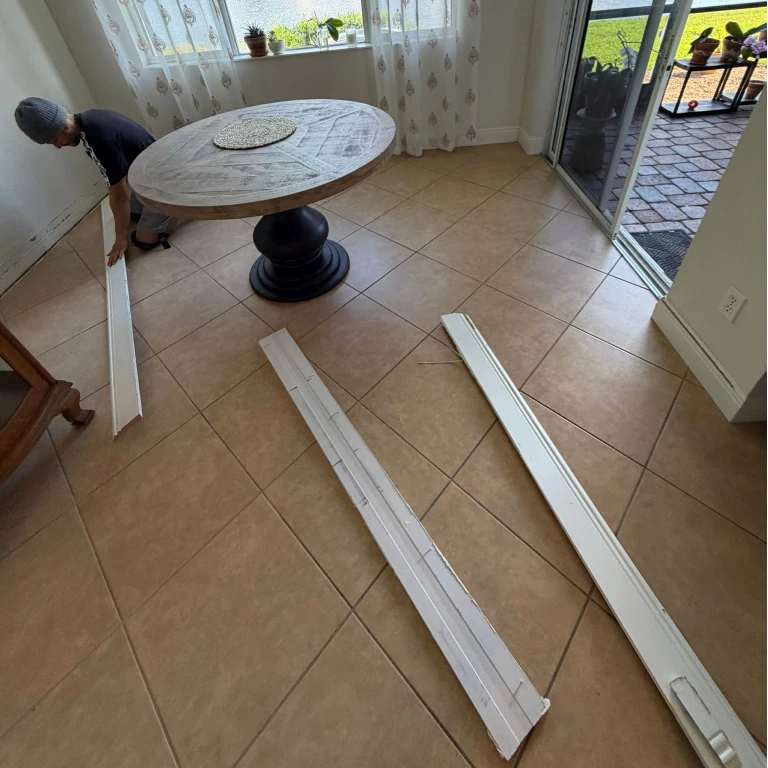Dining room with beige ceramic tile flooring before renovation — baseboards removed and ready for Waterproof Luxury Vinyl Plank 5.5mm installation in Gala Orchard