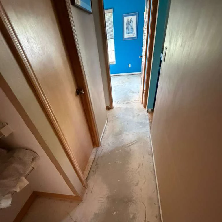 Hallway Flooring Preparation Before Vinyl Installation Hallway with exposed concrete subfloor before luxury vinyl plank flooring installation