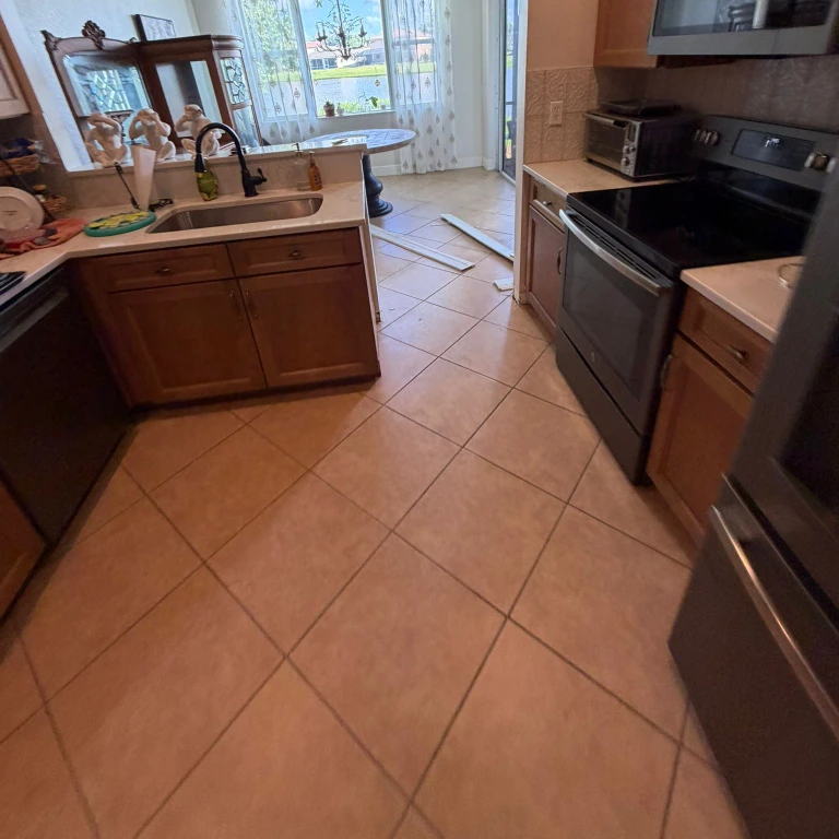 Kitchen with original beige ceramic tile flooring before replacement with Waterproof Luxury Vinyl Plank 5.5mm in Gala Orchard